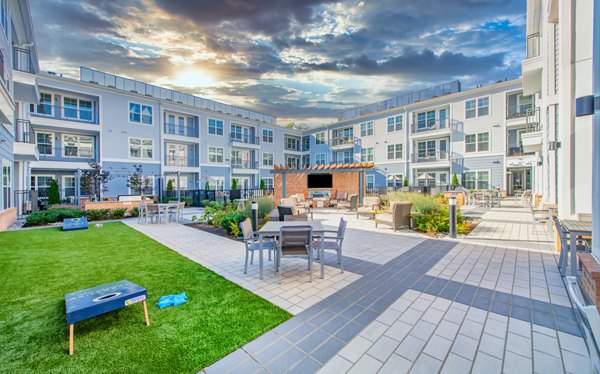 Tranquil courtyard with lush greenery at Overture Centennial Apartments, offering serene outdoor spaces for relaxation in a luxury community