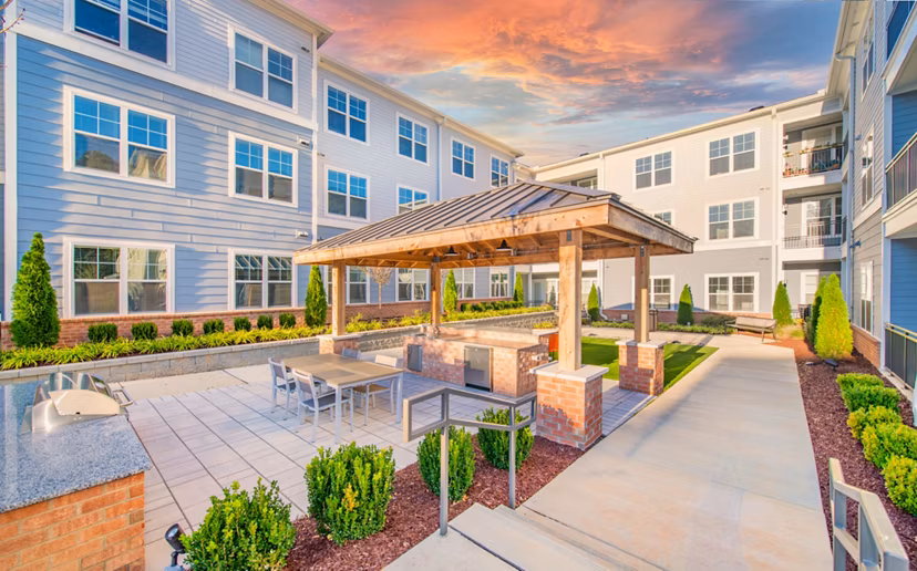 Outdoor grill area with modern seating at Overture Centennial Apartments, a luxury property managed by Greystar