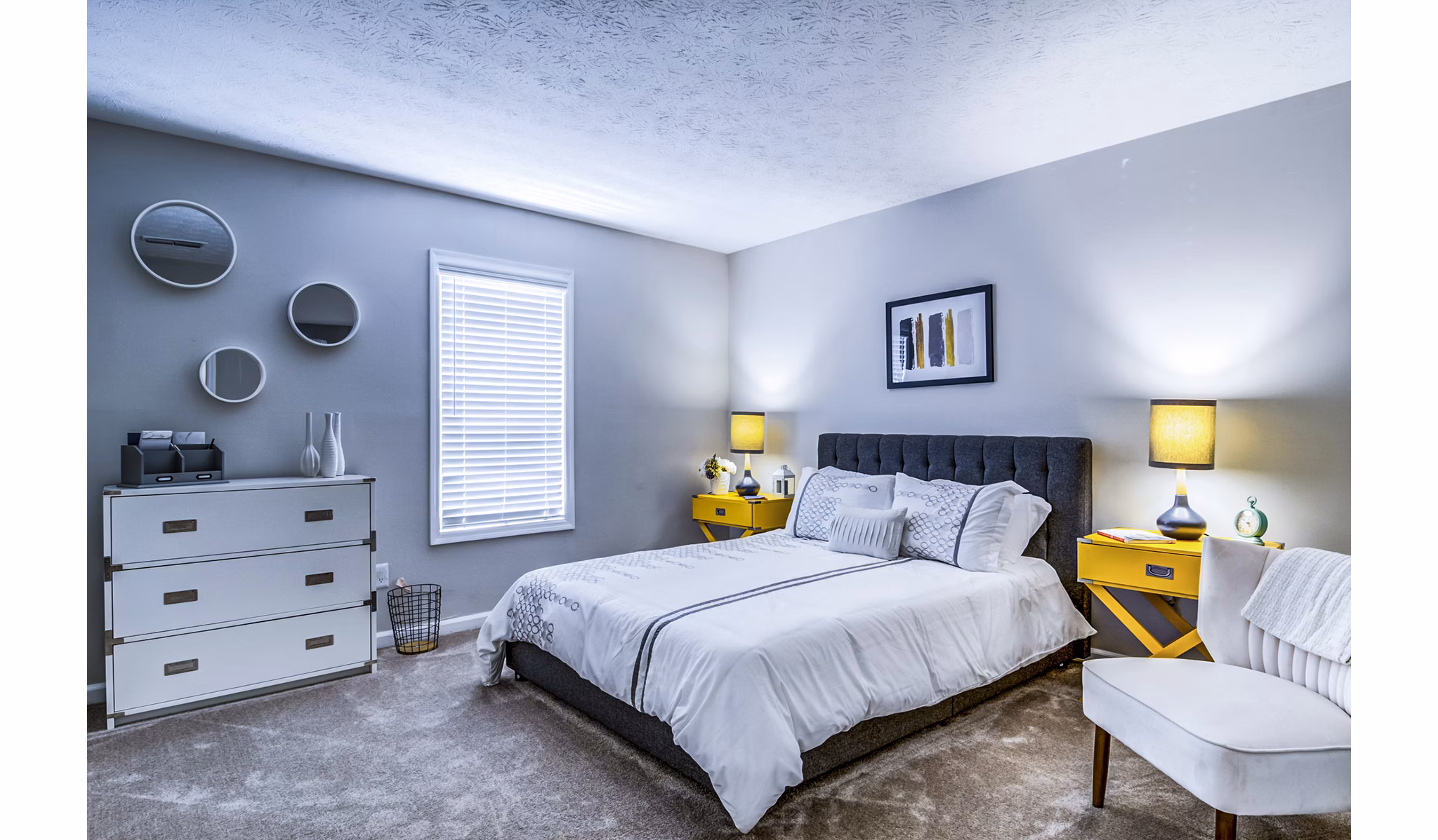 Elegant bedroom with modern furnishings at Junction at Vinings Apartments