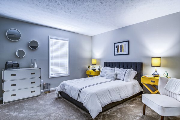 Elegant bedroom with modern furnishings at Junction at Vinings Apartments