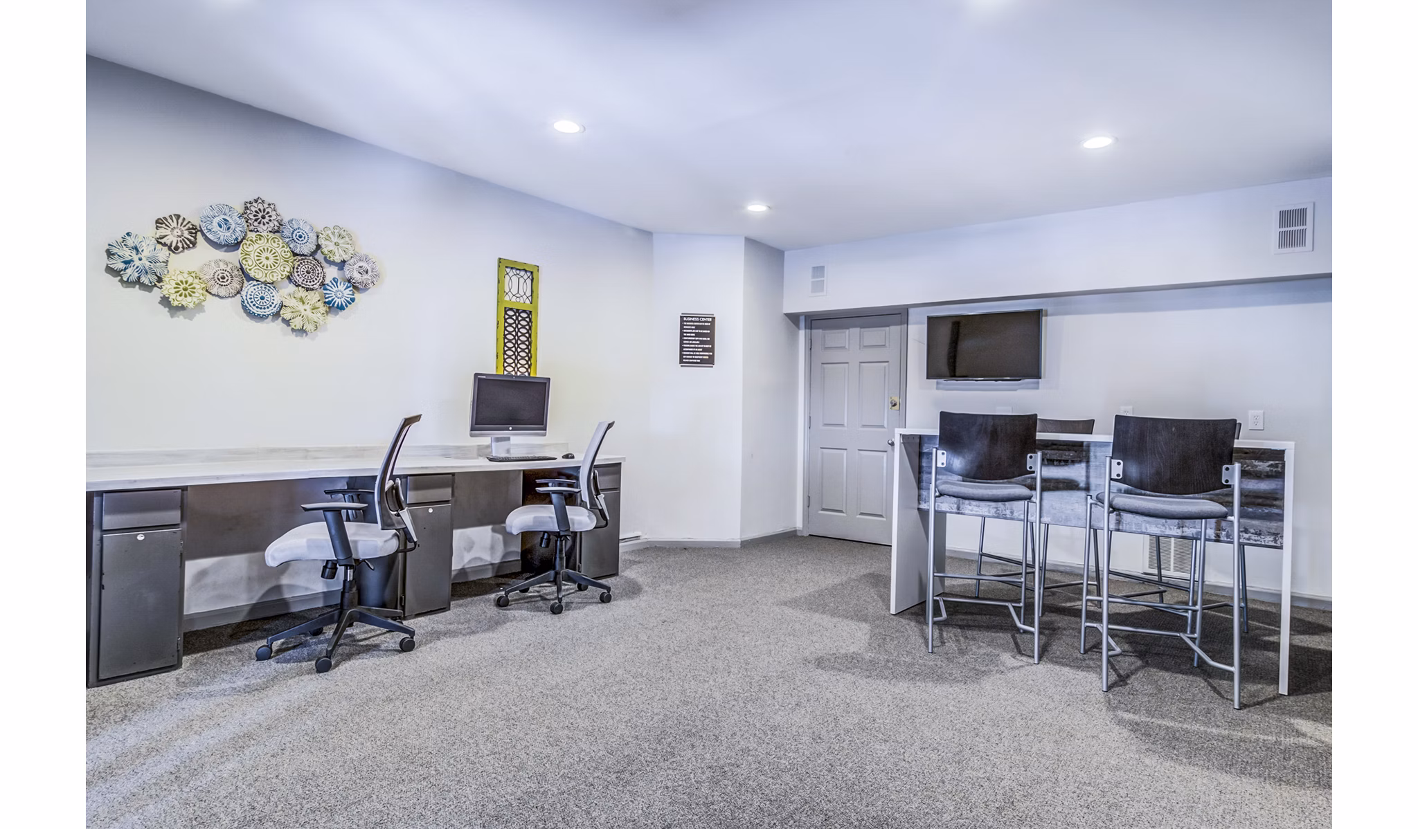 Business center with modern workstations at Junction at Vinings Apartments, offering a productive workspace for residents in a luxury community