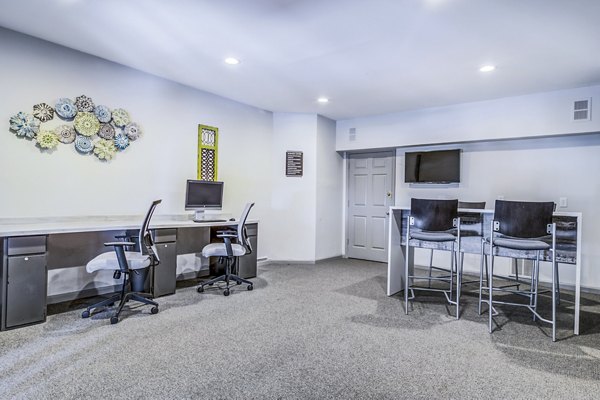 Business center with modern workstations at Junction at Vinings Apartments, offering a productive workspace for residents in a luxury community