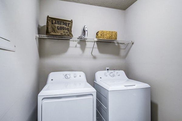 Laundry room featuring modern machines at Junction at Vinings Apartments