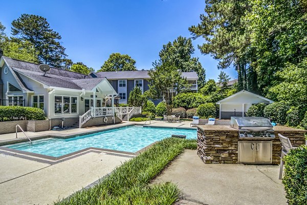 Pool and grill area at Junction at Vinings Apartments: Luxury outdoor amenities for relaxation and entertainment