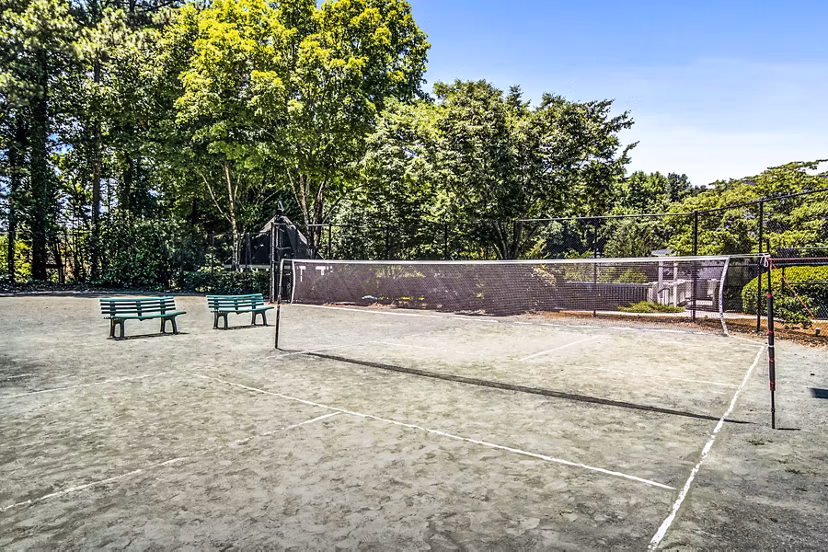 Volleyball court at Junction at Vinings Apartments featuring sand and net for recreation and sports activities