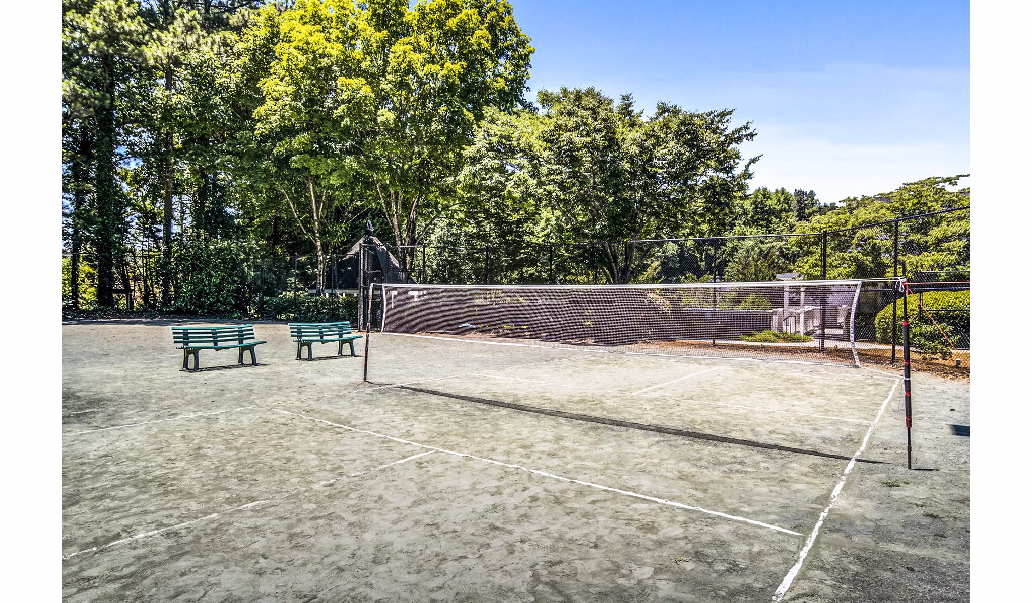 Volleyball court at Junction at Vinings Apartments featuring sand and net for recreation and sports activities