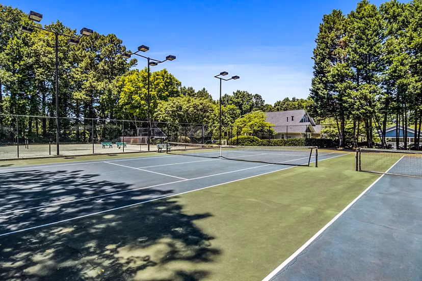 Outdoor tennis court at Junction at Vinings Apartments featuring modern facilities for residents