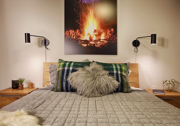 Cozy bedroom with modern decor at SOVA Apartments, featuring stylish furnishings in a luxury apartment setting