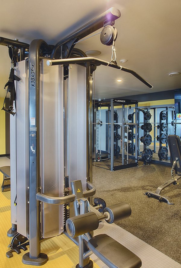 Modern fitness center with state-of-the-art equipment at SOVA Apartments, offering diverse workout options for residents' active lifestyles