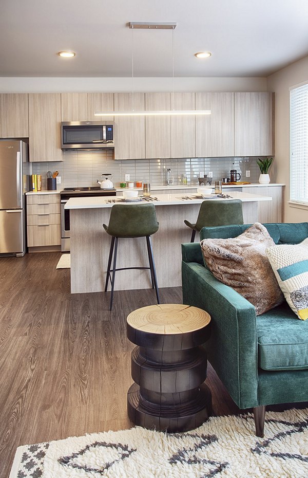 Elegant living room with modern furnishings at SOVA Apartments featuring luxury interiors, optimal for urban living in a vibrant setting