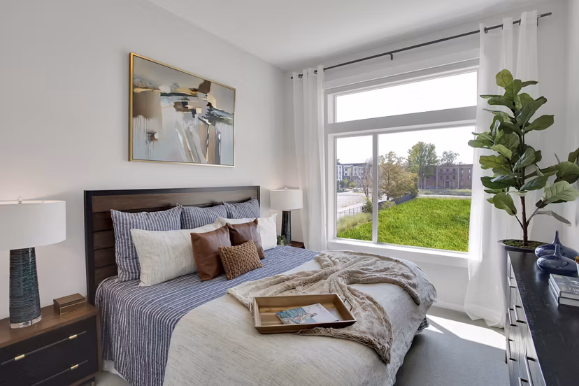 Modern bedroom featuring stylish decor in Overture 9th + CO Apartments, a luxury residence by Greystar in vibrant urban setting