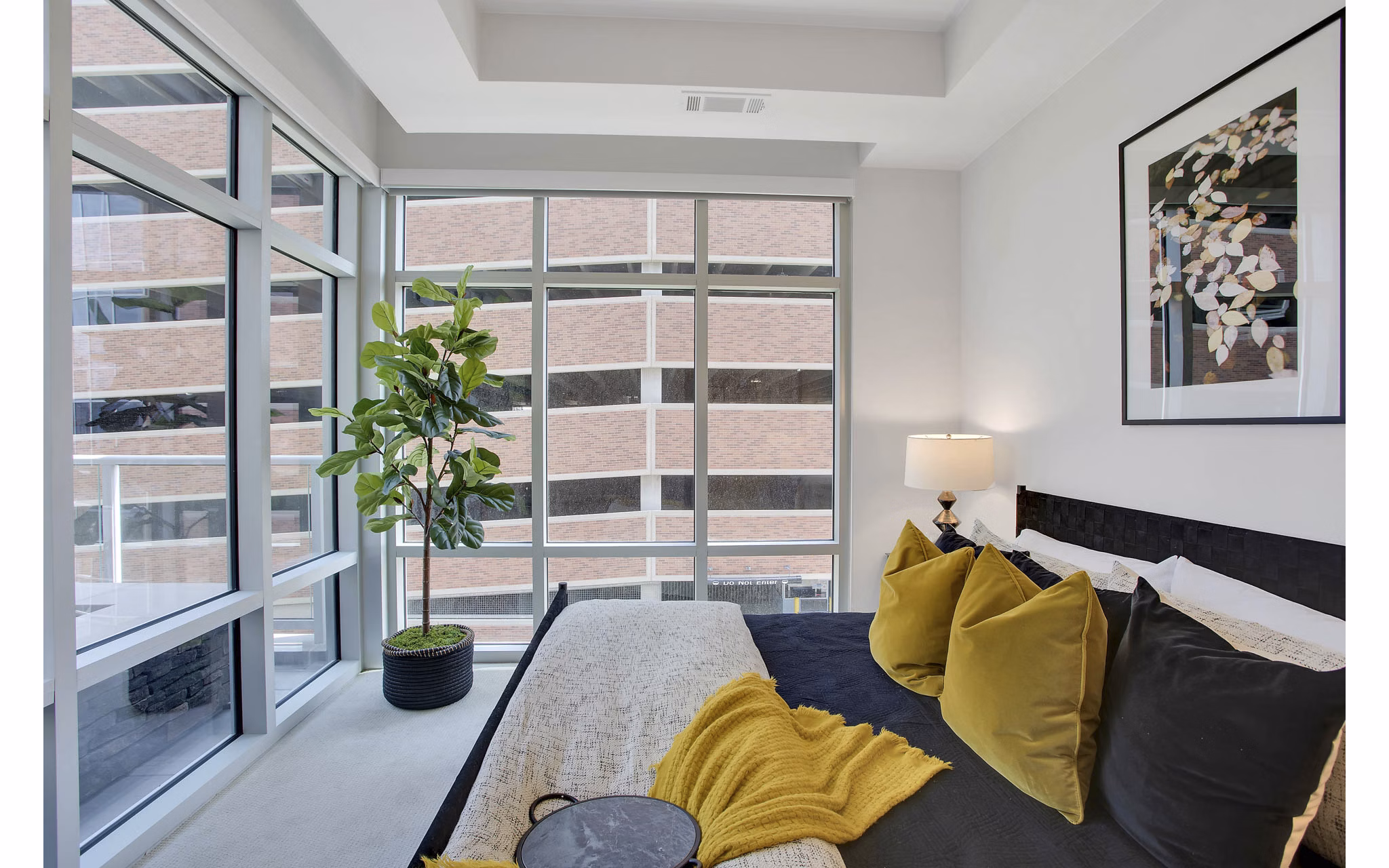 Modern bedroom with elegant furnishings at Overture 9th + CO Apartments, a luxury Greystar property located in a premium urban setting