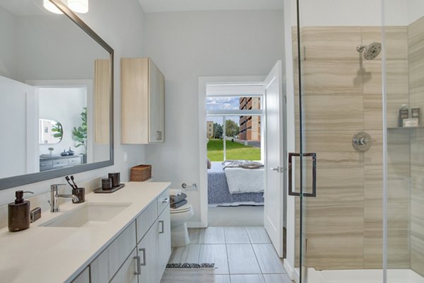 Modern bathroom with elegant fixtures at Overture 9th + CO Apartments, offering luxury living in a vibrant Denver community