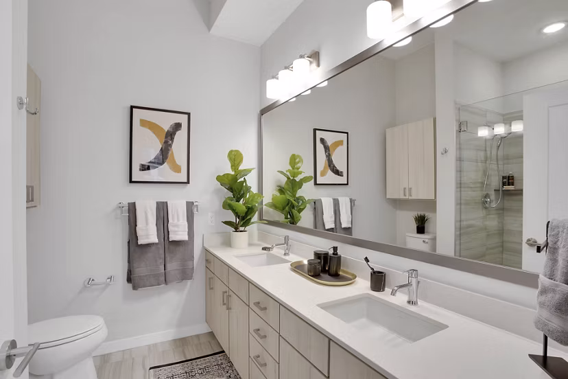 Modern bathroom with sleek fixtures and ample lighting at Overture 9th + CO Apartments