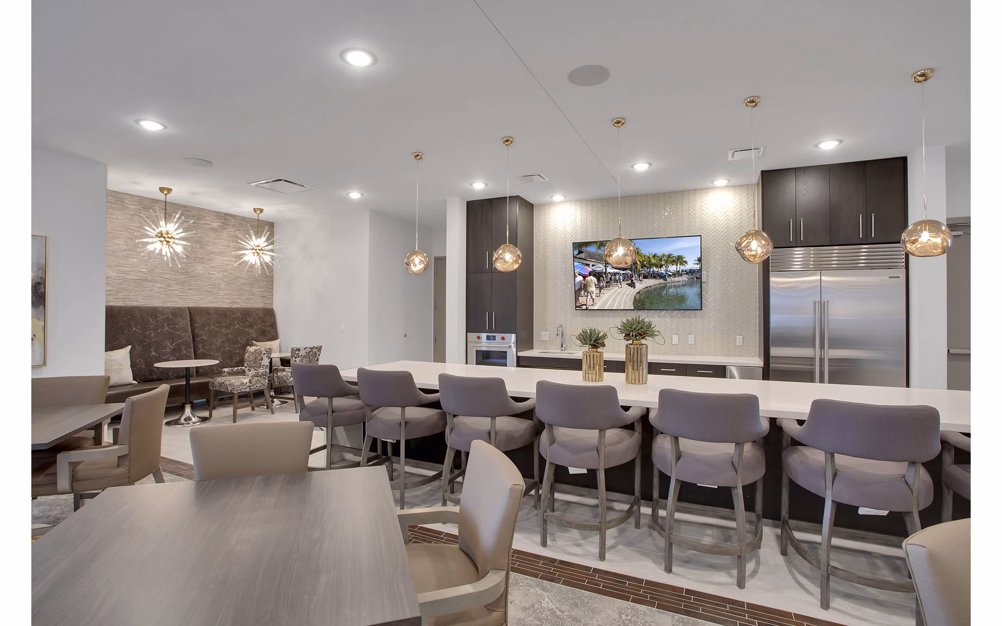 Clubhouse interior featuring modern furnishings and community workspace at Overture 9th + CO Apartments