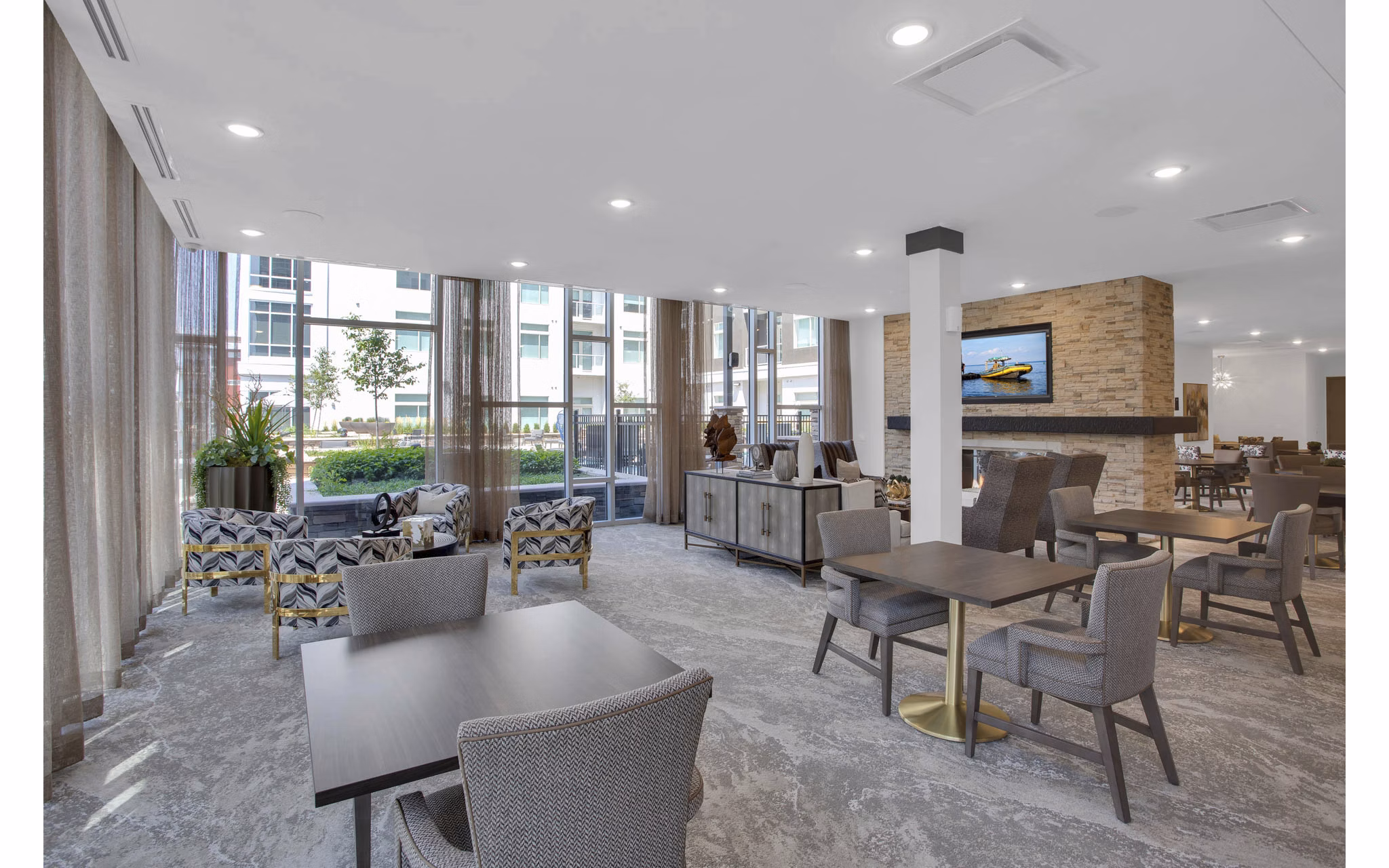 Modern clubhouse with cozy seating and fireplace at Overture 9th + CO Apartments