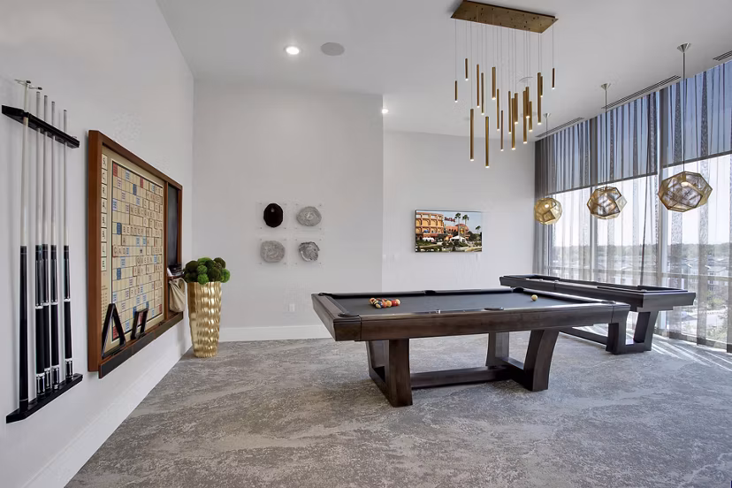 Modern game room with pool table and lounge seating at Overture 9th + CO luxury apartments