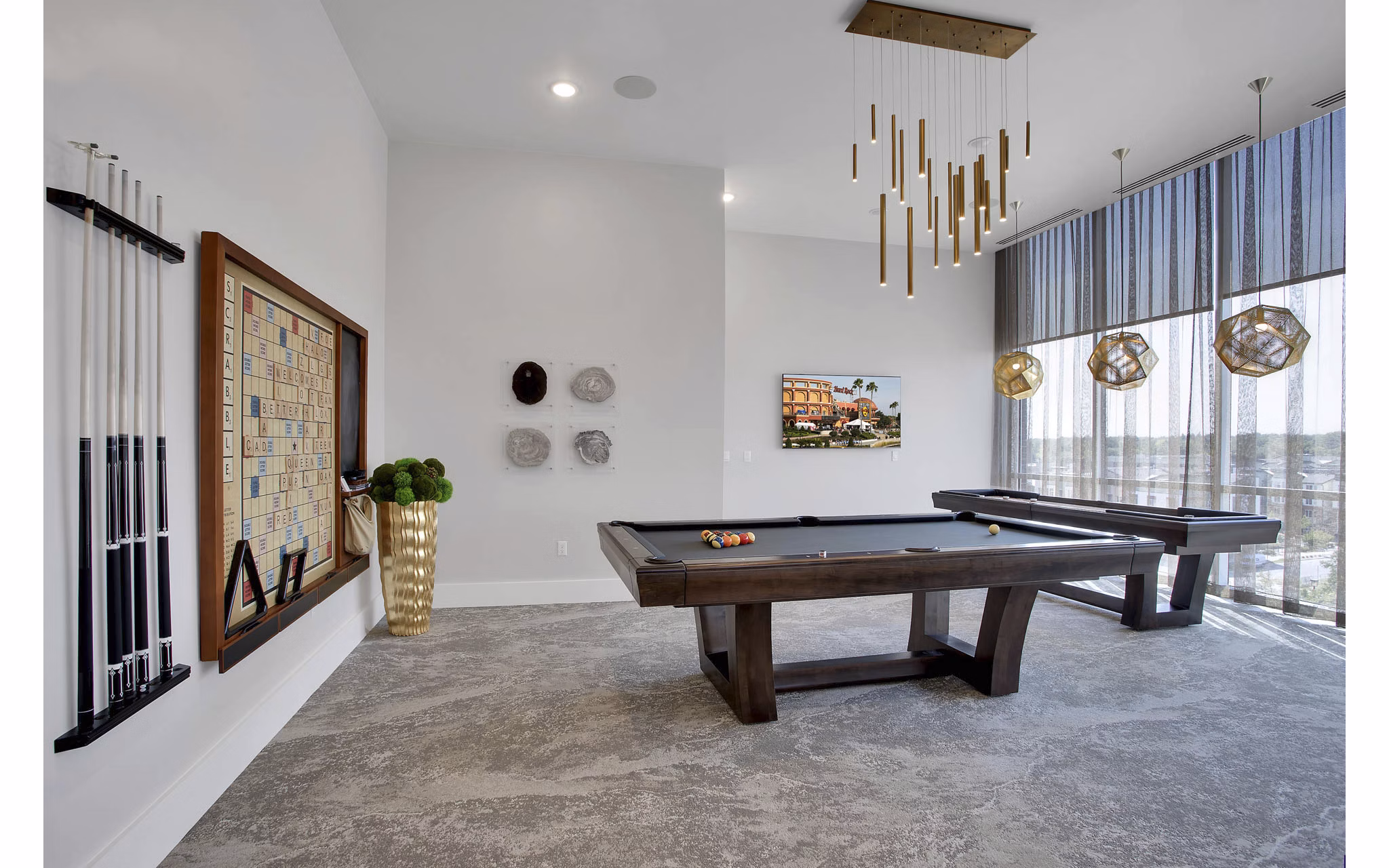 Modern game room with pool table and lounge seating at Overture 9th + CO luxury apartments