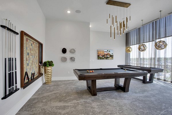 Modern game room with pool table and lounge seating at Overture 9th + CO luxury apartments