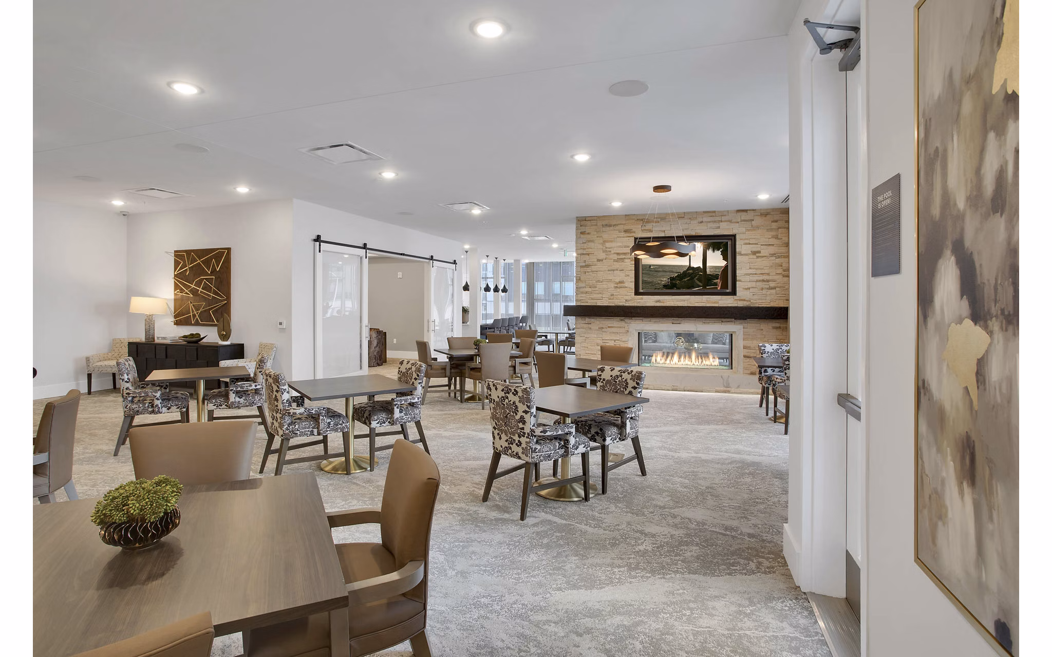 Stylish clubhouse with modern furnishings at Overture 9th + CO Apartments, perfect for leisure and gatherings in a luxury setting