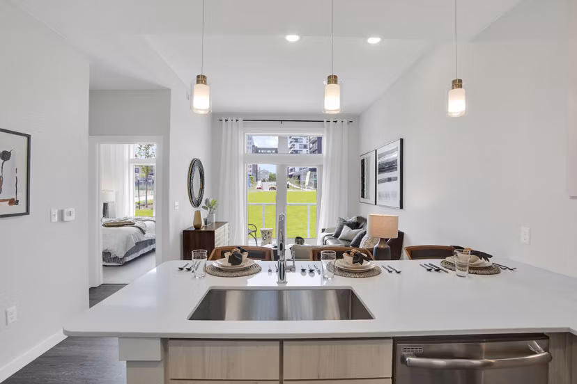Modern kitchen with stainless steel appliances at Overture 9th + CO Apartments, luxury living in vibrant location
