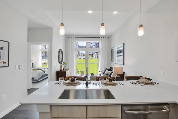 Modern kitchen with stainless steel appliances at Overture 9th + CO Apartments, luxury living in vibrant location