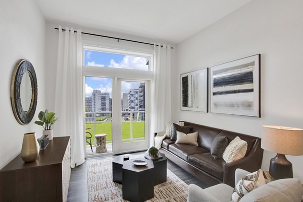 Spacious living room with modern furnishings at Overture 9th + CO Apartments