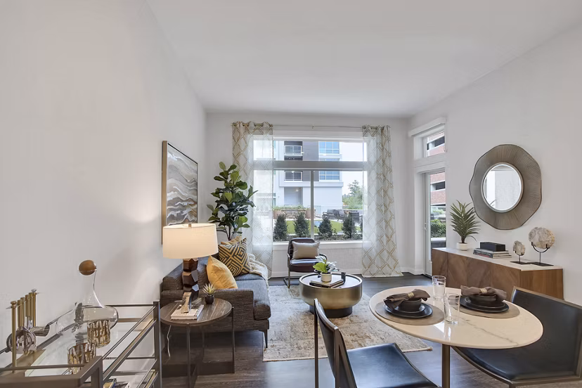 Modern living room with sleek furniture and large windows at Overture 9th + CO Apartments