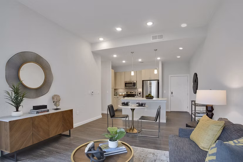 Modern living room with sleek furnishings and ample natural light at Overture 9th + CO Apartments