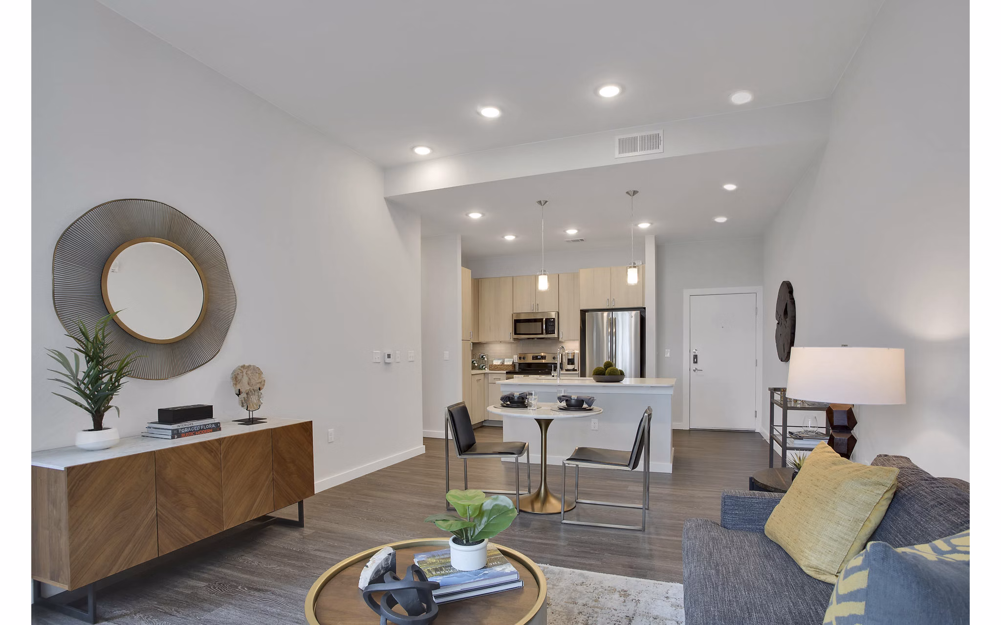 Modern living room with sleek furnishings and ample natural light at Overture 9th + CO Apartments