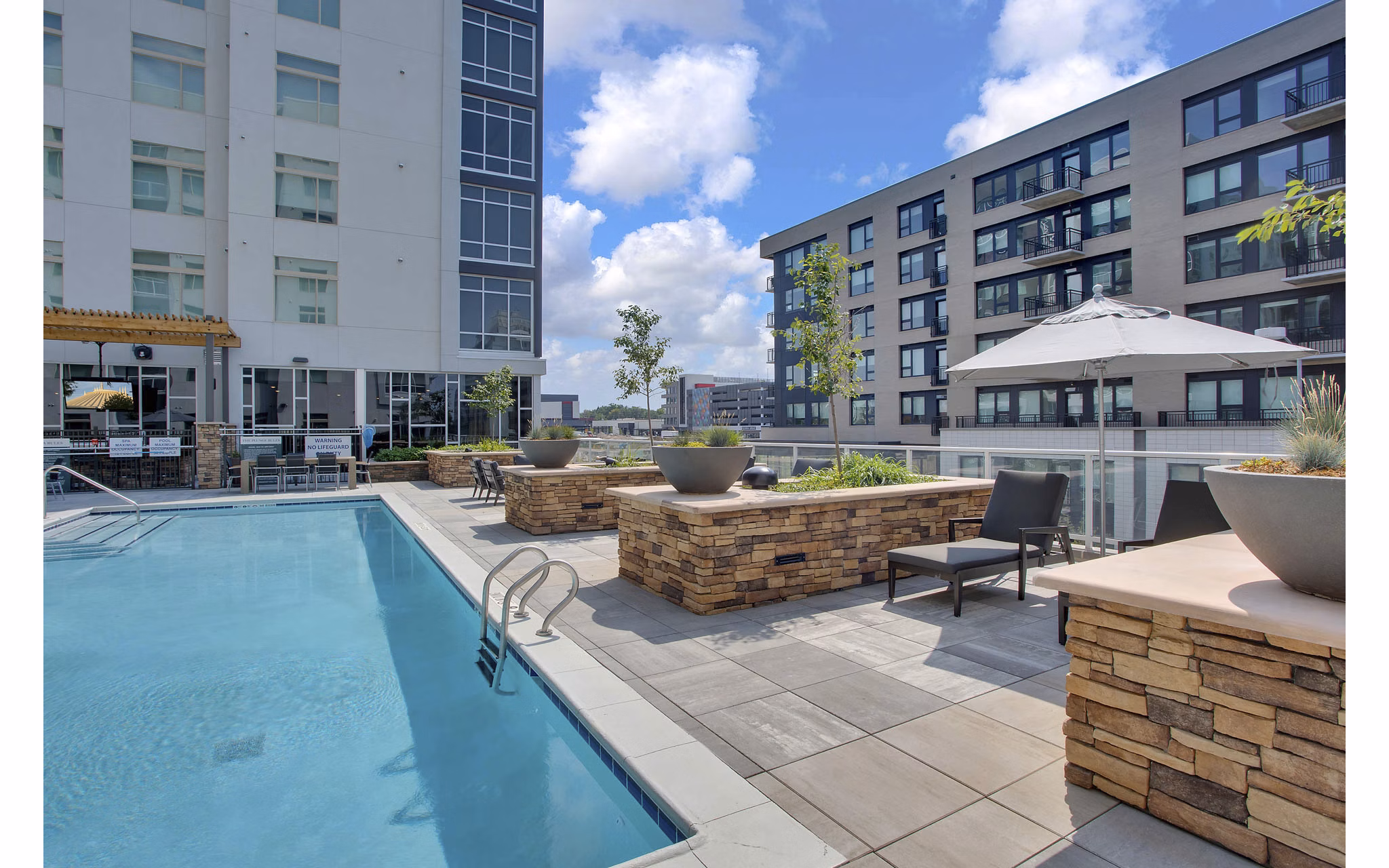 Rooftop pool offering city views at Overture 9th + CO Apartments