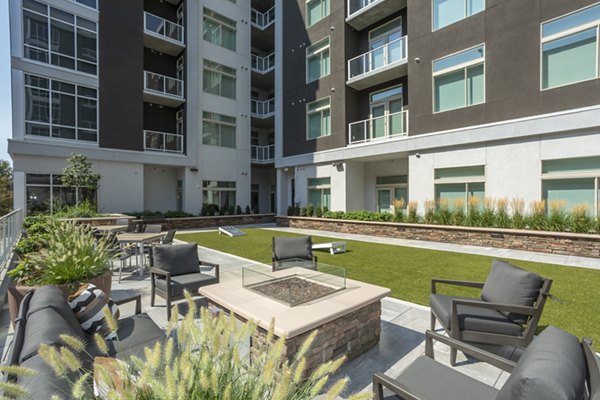Cozy outdoor fire pit area at Overture 9th + CO Apartments, perfect for social gatherings and relaxation
