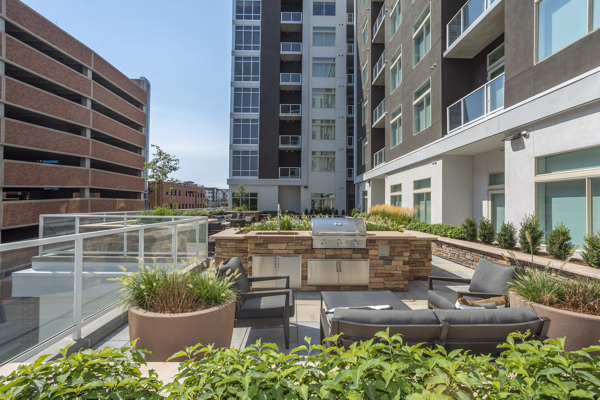 Grill area with modern seating at Overture 9th + CO Apartments, a luxury property offering urban living