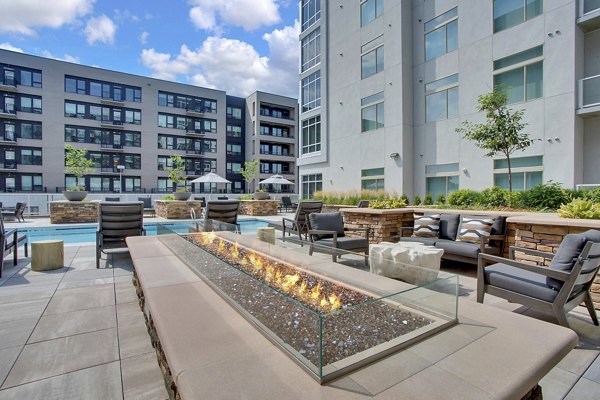 Cozy outdoor fire pit at Overture 9th + CO Apartments, perfect for relaxing evenings and social gatherings in a luxurious setting