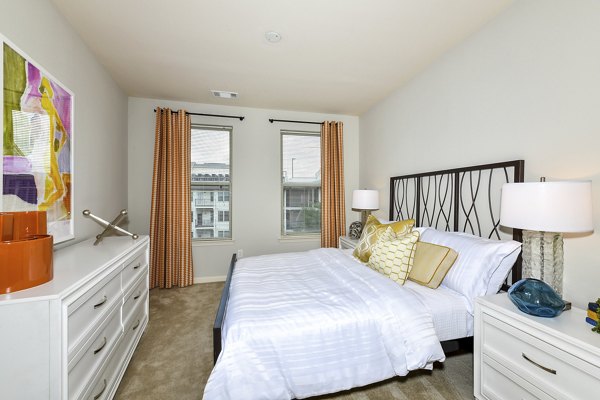 Cozy bedroom with modern decor at Avana on Main Apartments, part of Greystar luxury apartments collection