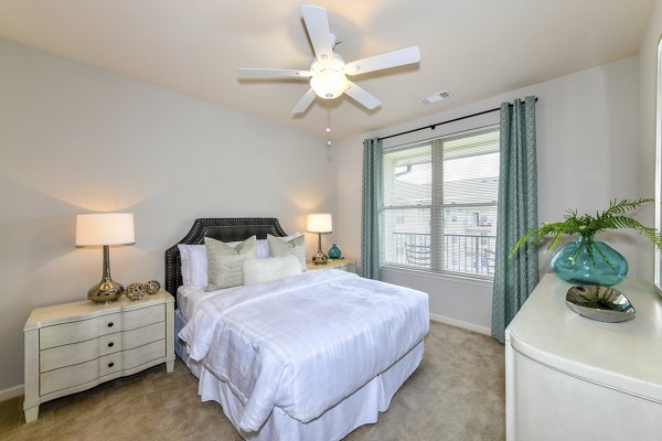 Cozy bedroom with modern decor at Avana on Main Apartments
