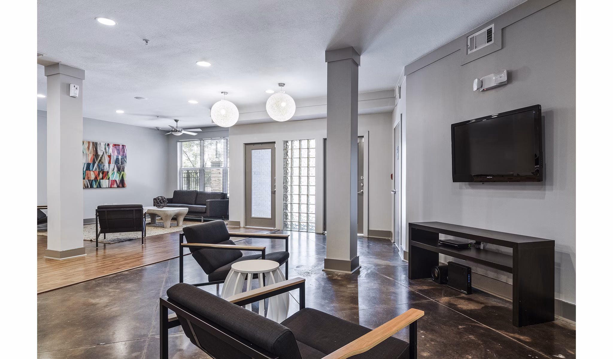 Lobby area featuring a contemporary design and cozy seating at Avana on Main Apartments