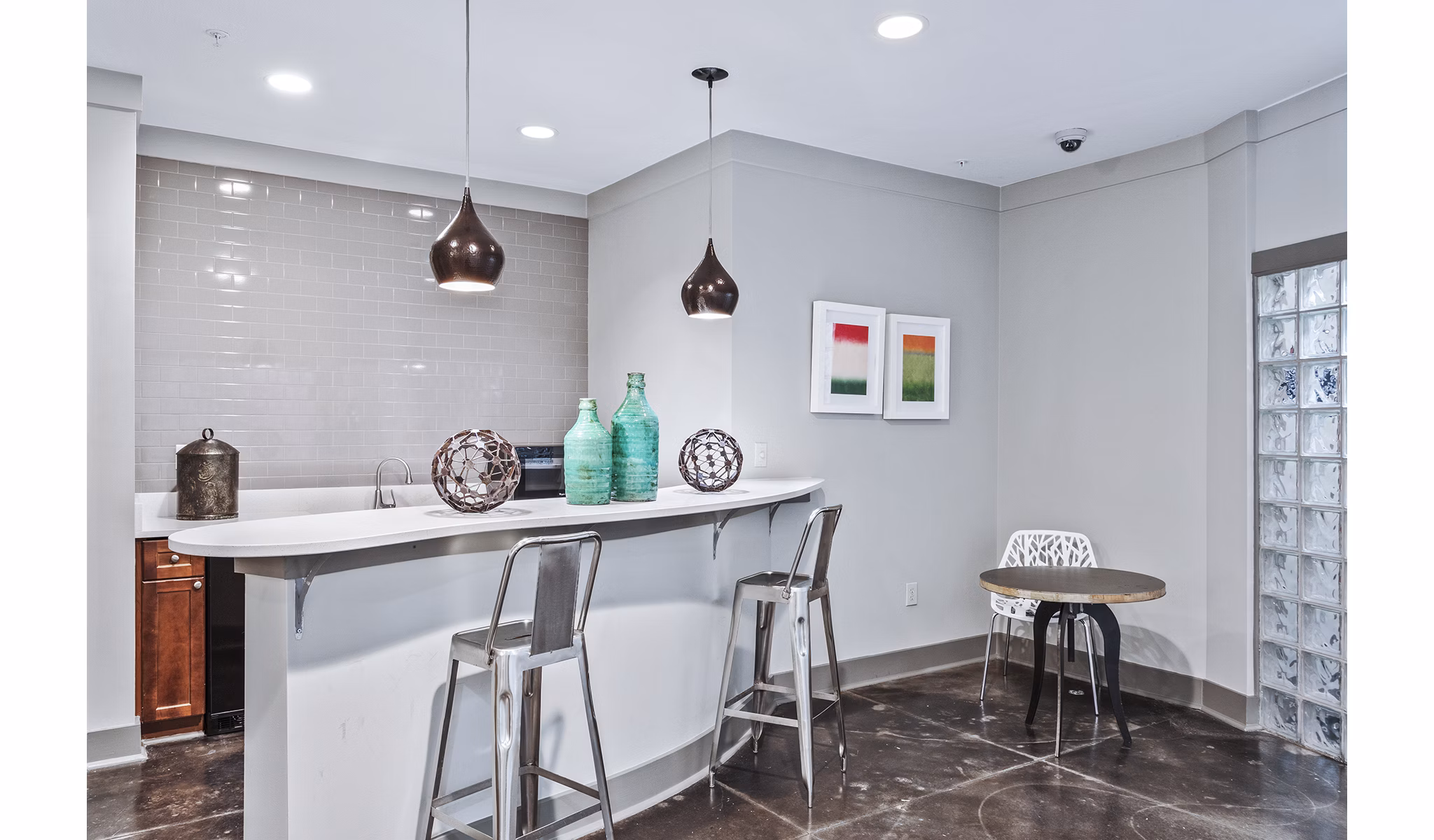 Clubhouse lobby with modern decor and cozy seating at Avana on Main Apartments in luxury residential community