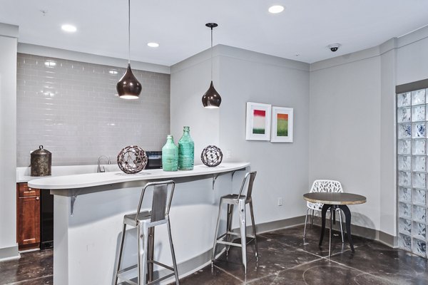 Clubhouse lobby with modern decor and cozy seating at Avana on Main Apartments in luxury residential community