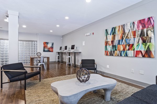 Clubhouse lobby with contemporary design and seating at Avana on Main Apartments