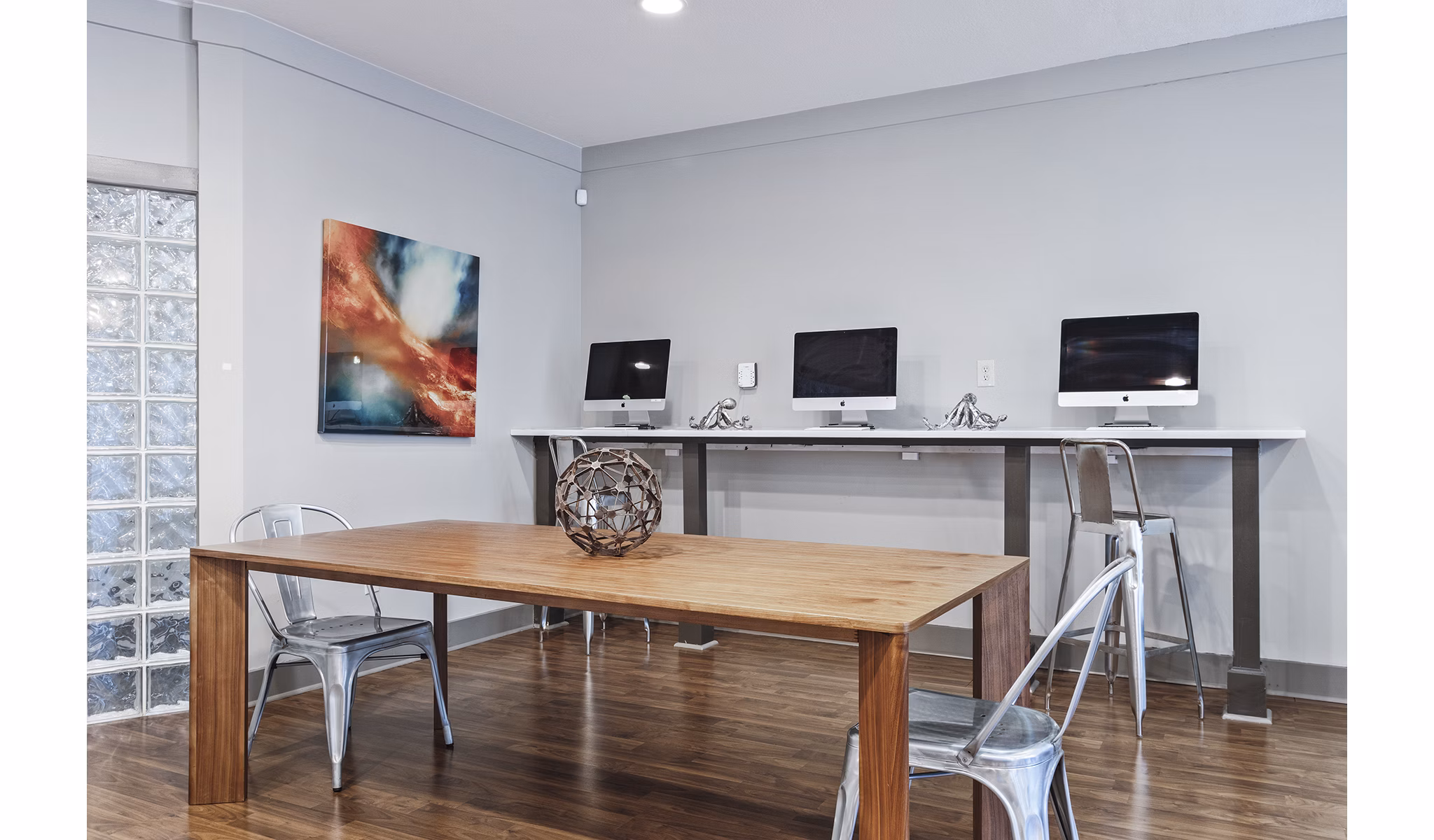 Business center with modern workstations at Avana on Main Apartments