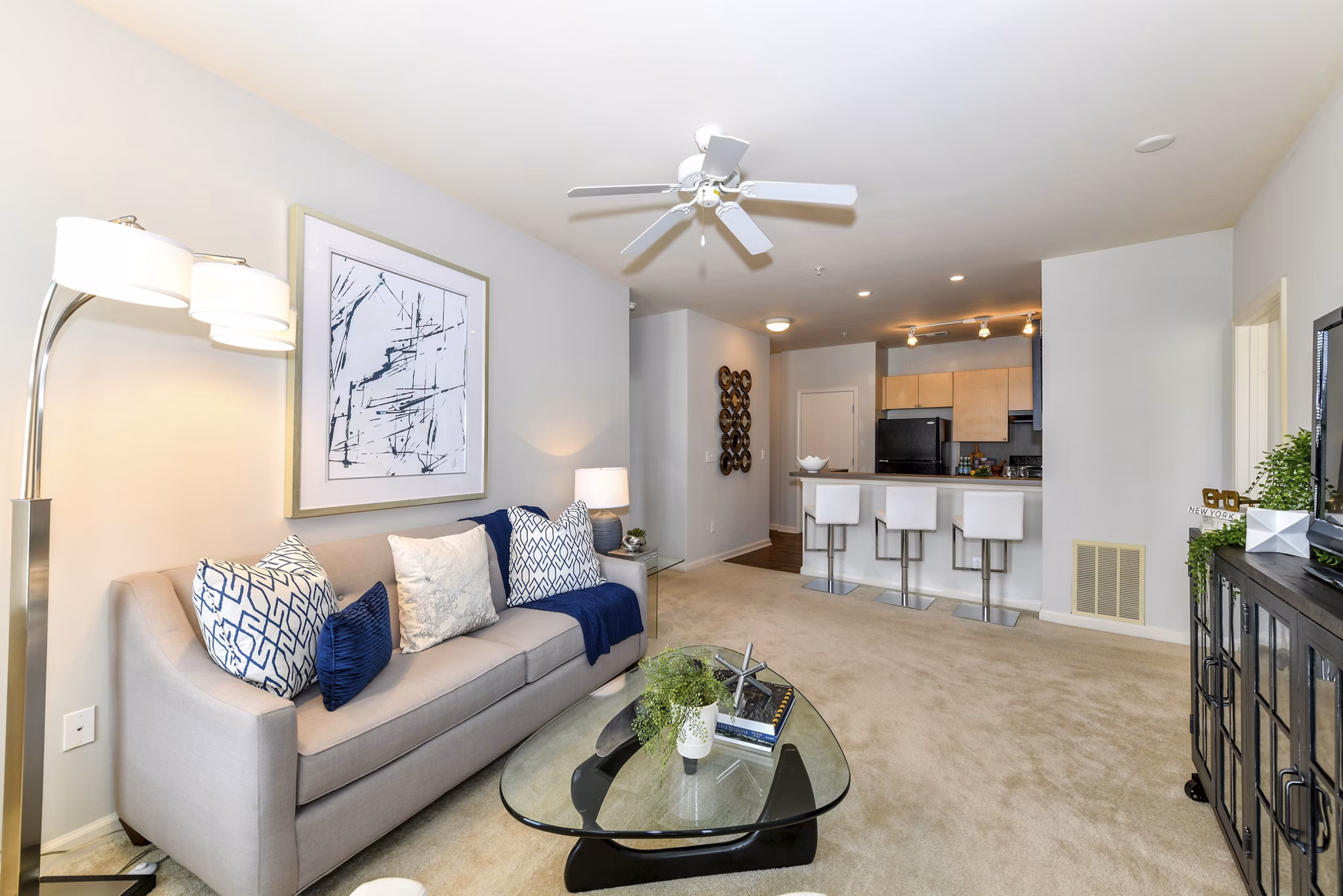 Bright living room with modern furnishings and large windows in Avana on Main Apartments