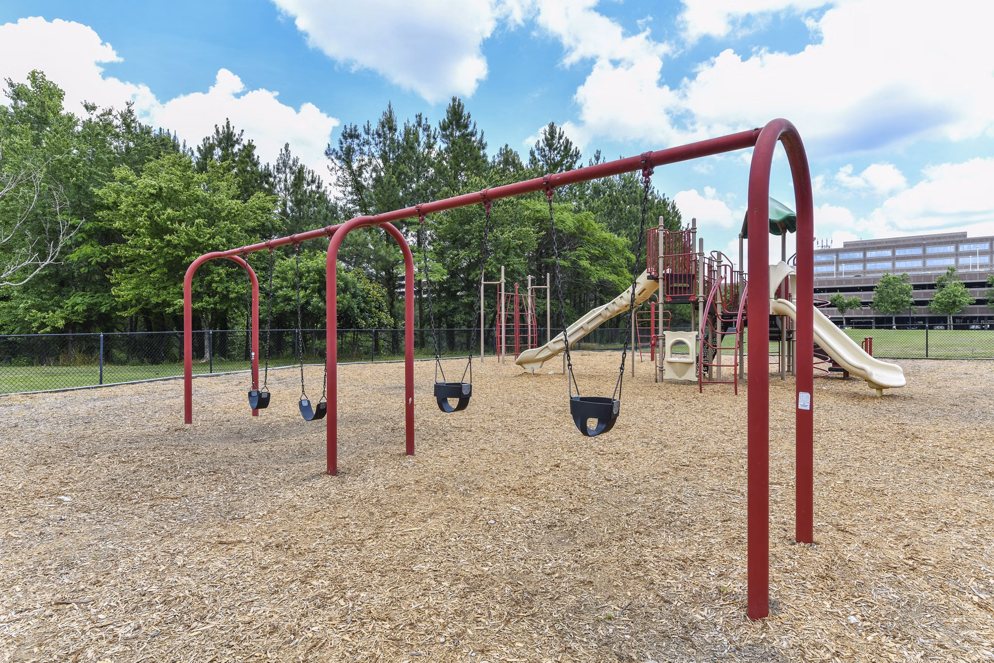 Children's playground with modern equipment at Avana on Main Apartments