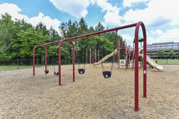Children's playground with modern equipment at Avana on Main Apartments