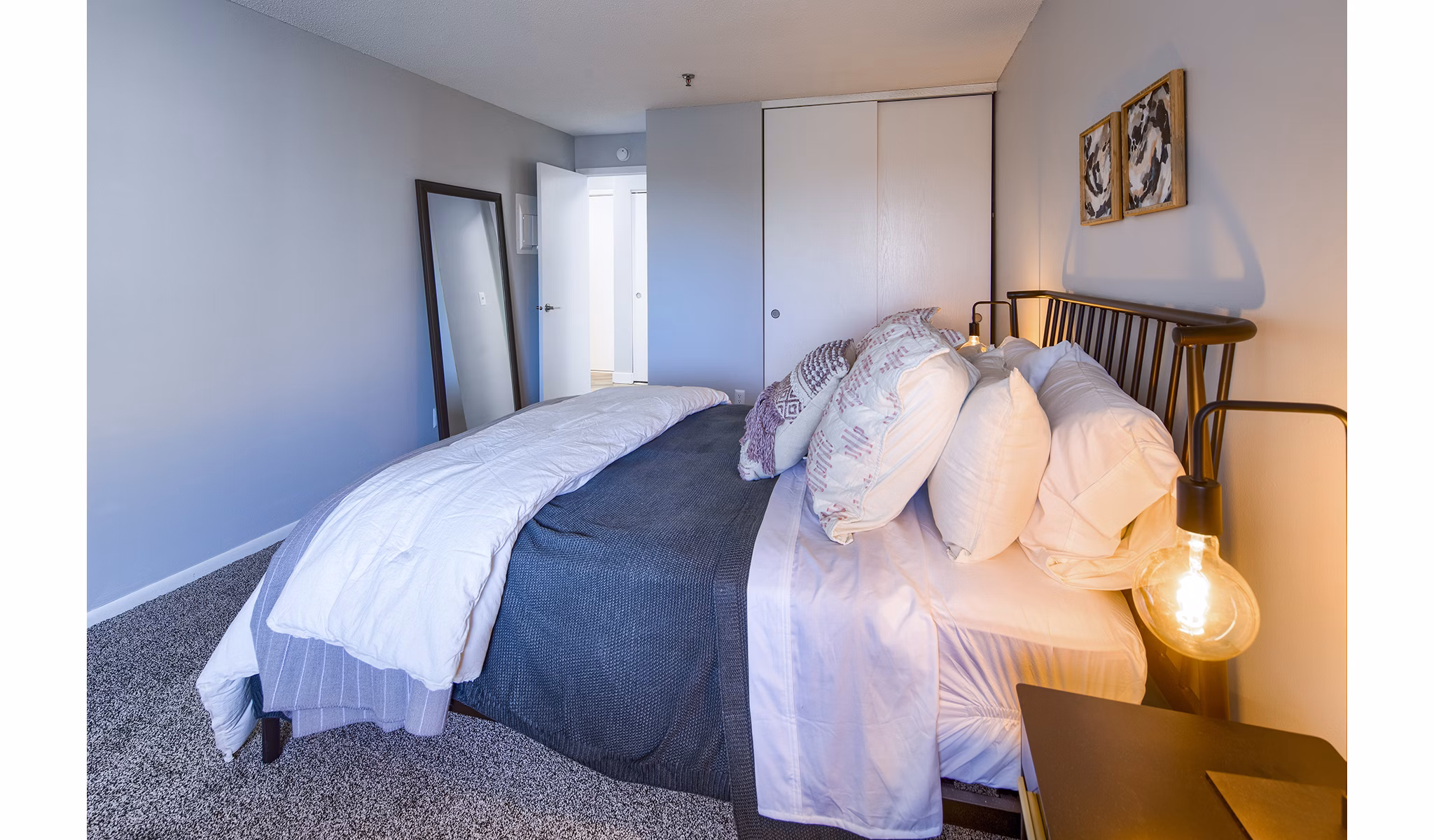 Elegant bedroom with plush bedding and natural light at Avana Southview Apartments