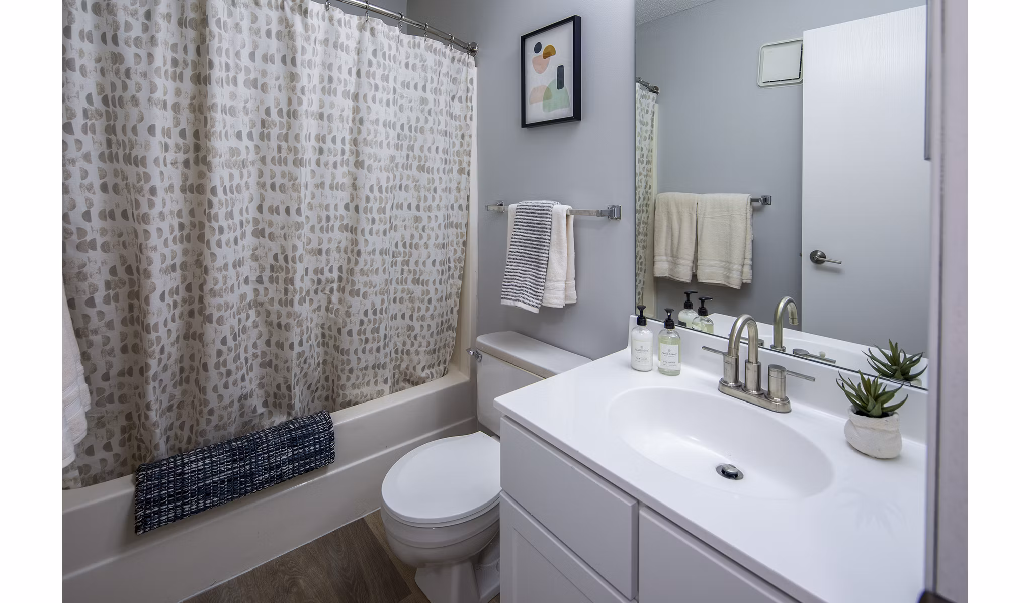 Modern bathroom with sleek fixtures and granite countertops in Avana Southview Apartments