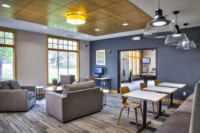 Clubhouse with modern furnishings and open seating at Avana Southview Apartments in a luxury setting