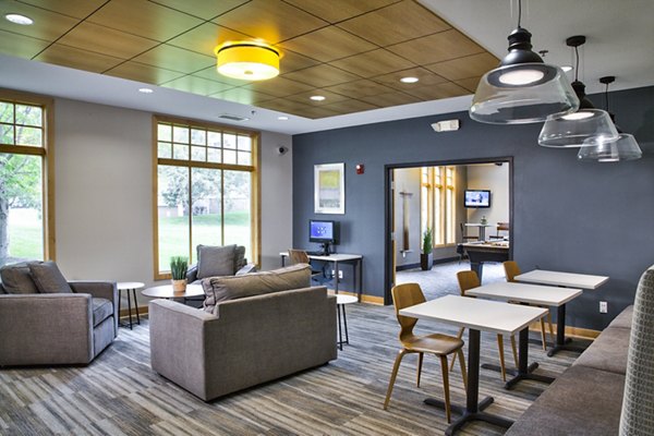 Clubhouse with modern furnishings and open seating at Avana Southview Apartments in a luxury setting