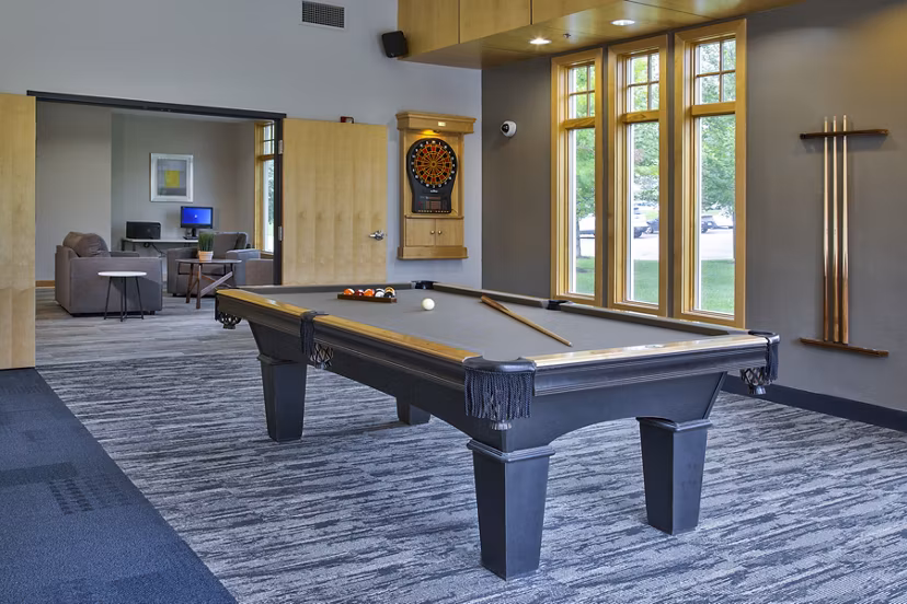 Game room featuring pool table and lounge seating at Avana Southview Apartments