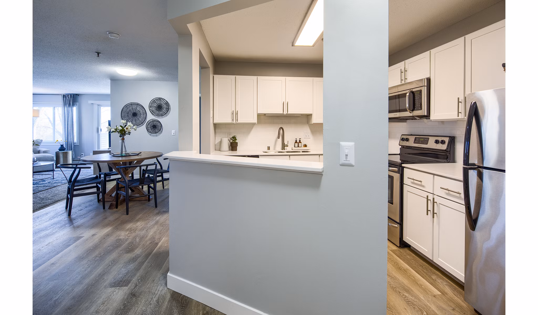 Modern kitchen with stainless steel appliances in Avana Southview Apartments, a Greystar luxury property